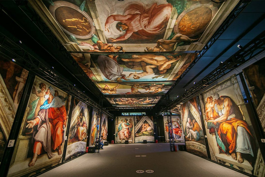 panels of the sistine chapel artworks displayed in an exhibition hall